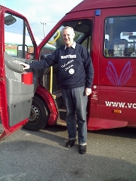 A photograph of a Handybus driver with the bus