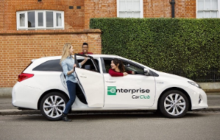 An Enterprise Car Club car parked on the road side.