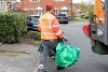 2025-recycling man carrying green bag and box to recycling van