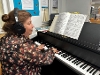 Frances playing the piano at Theale Library.